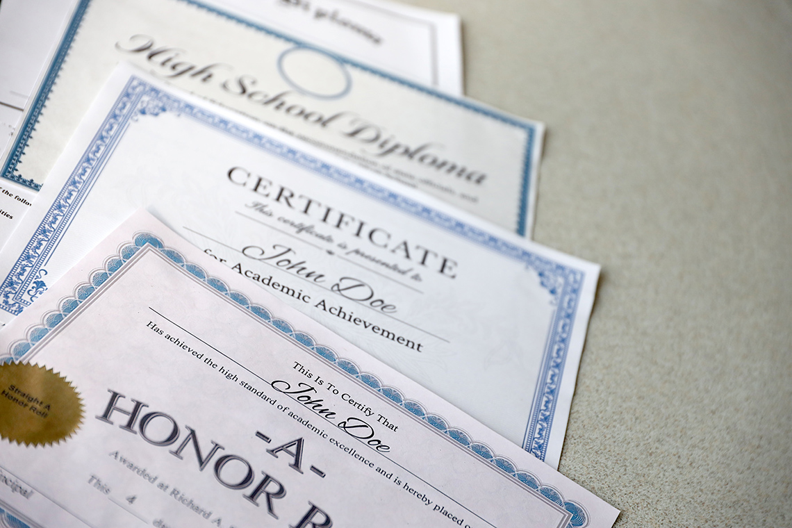 Image of a several paper with the words honors certificates on a table